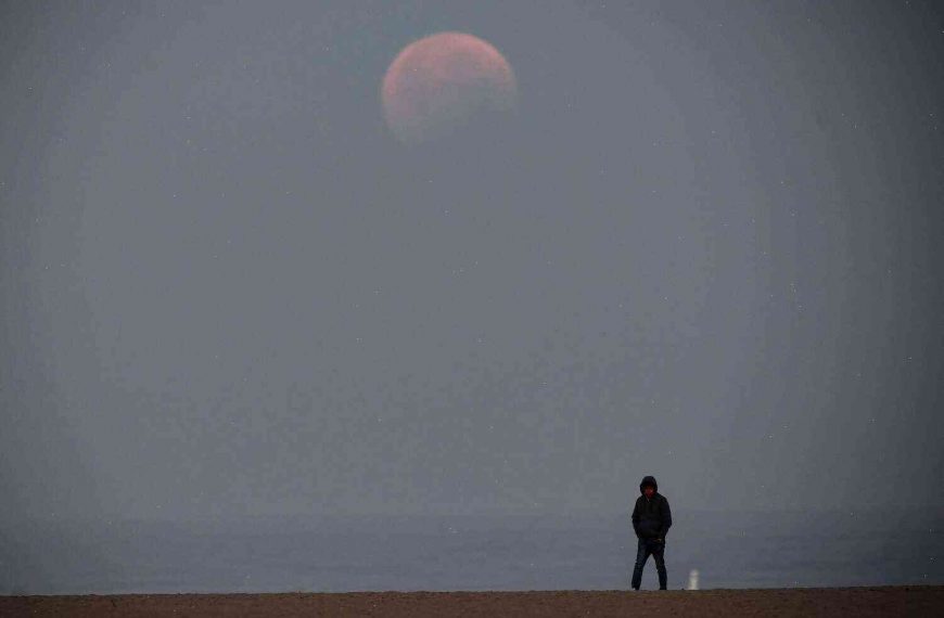The whitish glow of a red moon is the beginning of the Great American Eclipse