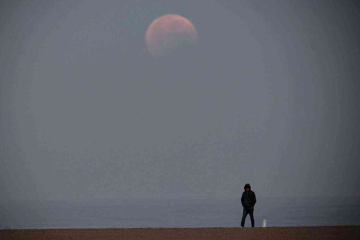 The whitish glow of a red moon is the beginning of the Great American Eclipse